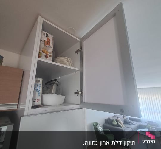 ארון מטבח פתוח עם קערה ומכשיר חשמלי